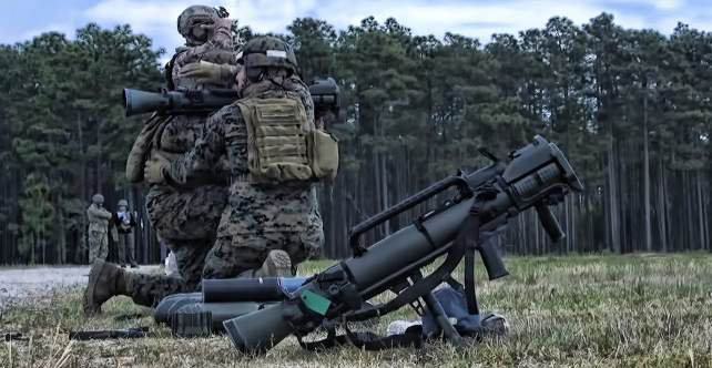 Soldiers carrying a recoilless weapon